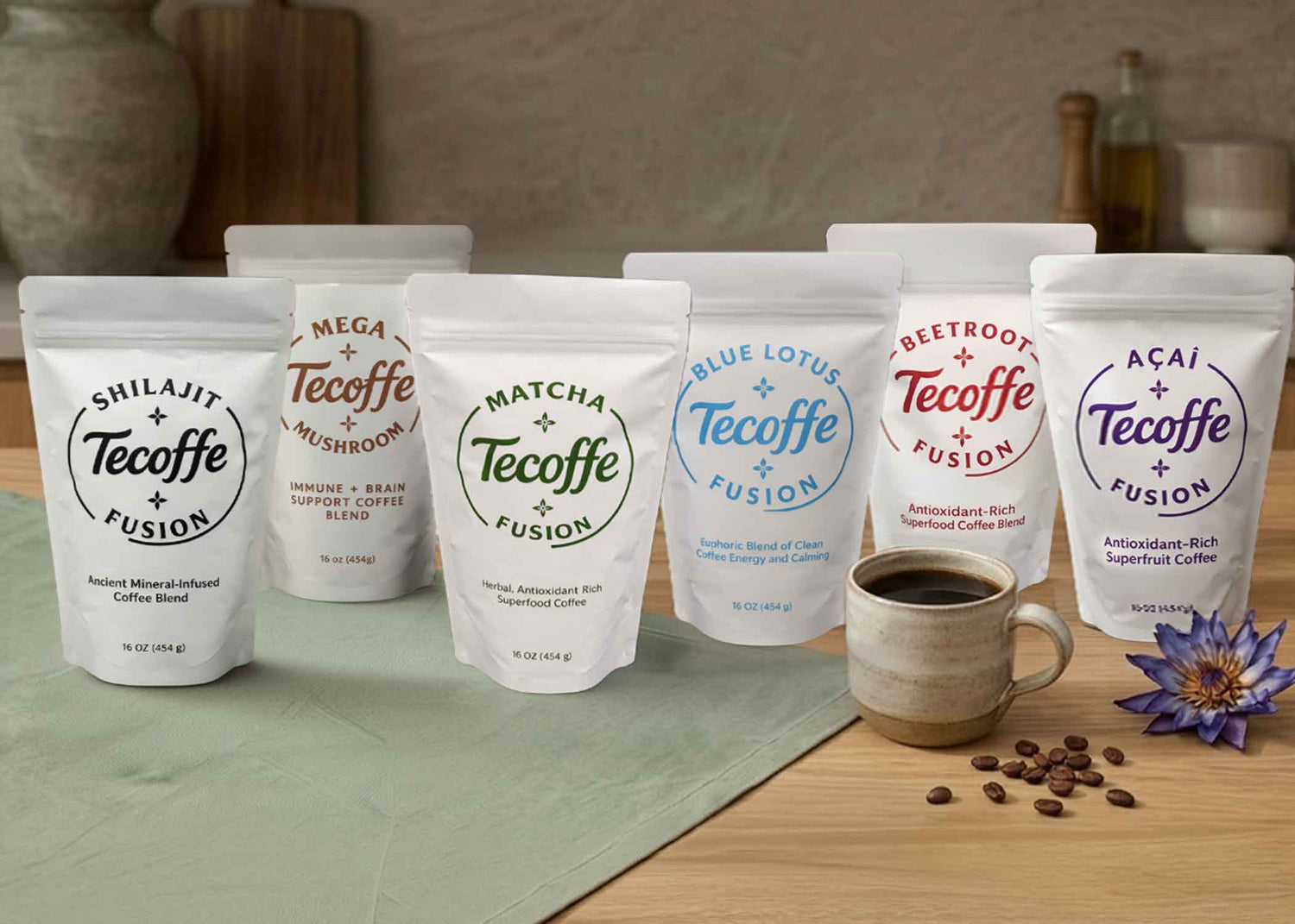 Assorted packages of Tecoffe Fusion coffee blends on a table with a mug and coffee beans.